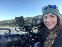 Nathalie Swain-Diaz on location with a RED camera behind her